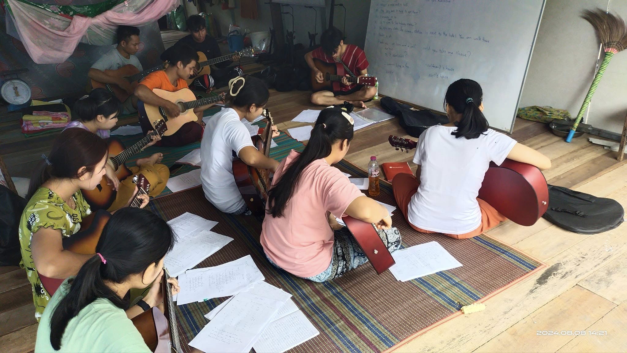 Mentor teaching traditional music to children